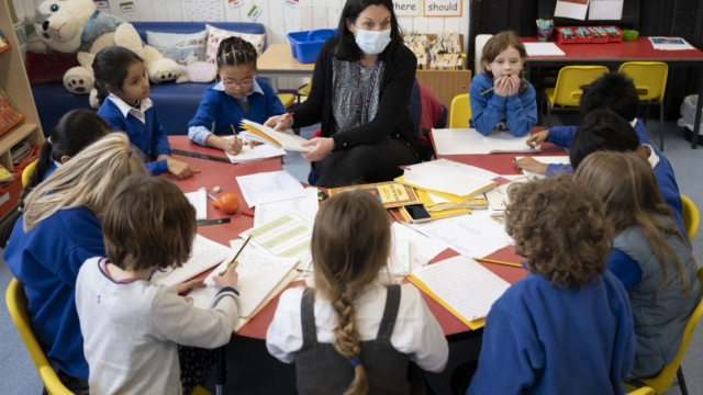 CARDIFF, WALES - FEBRUARY 23: A teacher holds a creative writing class at Roath Park Primary School on February 23, 2021 in Cardiff, Wales. Children aged three to seven began a phased return to school on Monday. Wales' education minister Kirsty Williams has said more primary school children will be able to return to face-to-face learning from March 15 if coronavirus cases continue to fall. (Photo by Matthew Horwood/Getty Images) *** BESTPIX ***